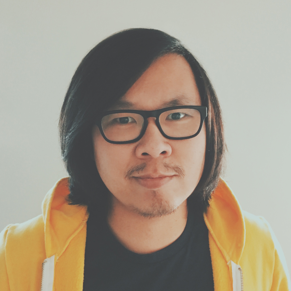 Headshot of Nick, an east asian dude, with black rimmed glasses wearing black t-shirt with a sunny yellow hoodie